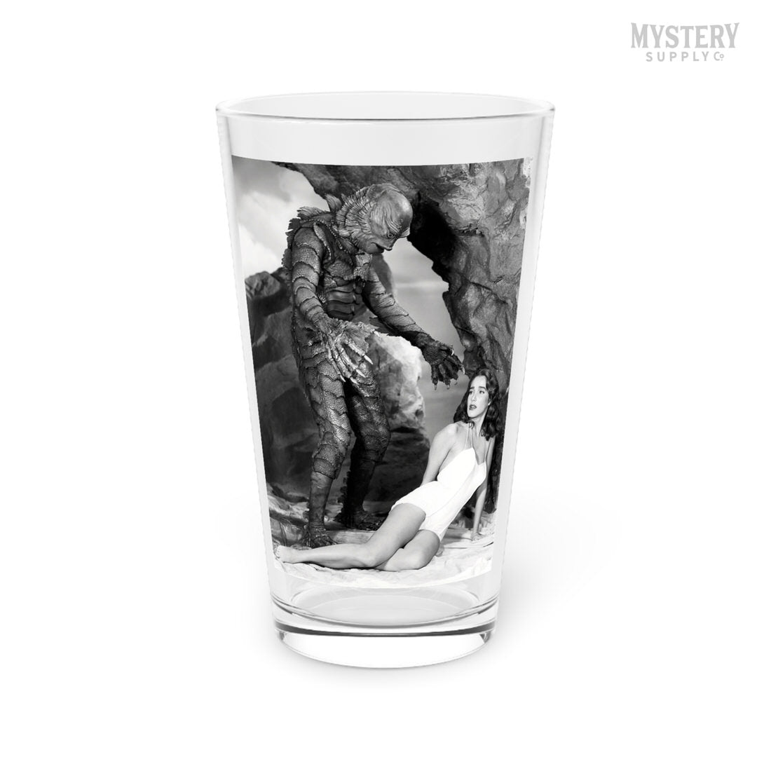 Creature from the Black Lagoon 1954 vintage horror monster Julie Adams swim suit and the gill man black and white photo reproduction 16oz pint glass home decor glassware from Mystery Supply Co. @mysterysupplyco