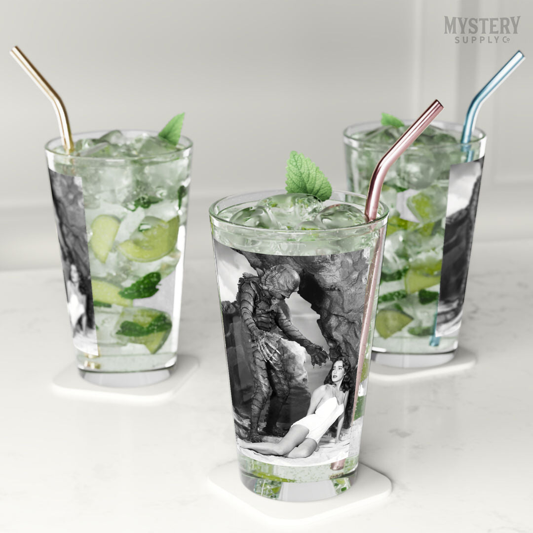 Creature from the Black Lagoon 1954 vintage horror monster Julie Adams swim suit and the gill man black and white photo reproduction 16oz pint glass home decor glassware from Mystery Supply Co. @mysterysupplyco