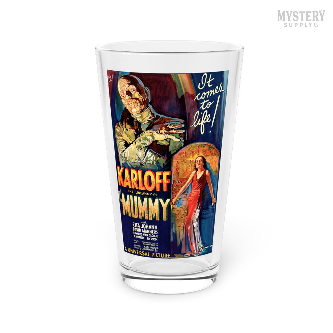 Glass tumbler with a vintage movie poster design featuring 'The Mummy' on a white background. The Mummy 1932 vintage Boris Karloff horror monster movie poster reproduction 16oz clear pint glass home decor glassware from Mystery Supply Co. @mysterysupplyco