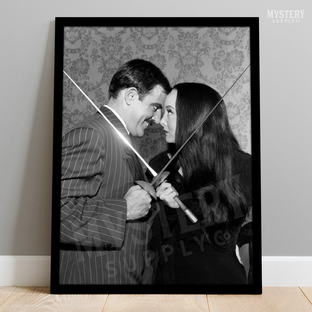 Morticia and Gomez Fencing 1960s Vintage Addams Family Black and White Photo Reproduction wall decor art print from Mystery Supply Co. @mysterysupplyco