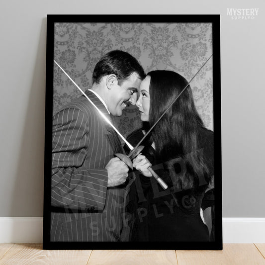 Morticia and Gomez Fencing 1960s Vintage Addams Family Black and White Photo Reproduction wall decor art print from Mystery Supply Co. @mysterysupplyco