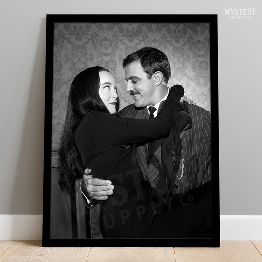 Gomez holding Morticia Addams 1960s vintage Addams family black and white photo reproduction wall decor art print from Mystery Supply Co. @mysterysupplyco