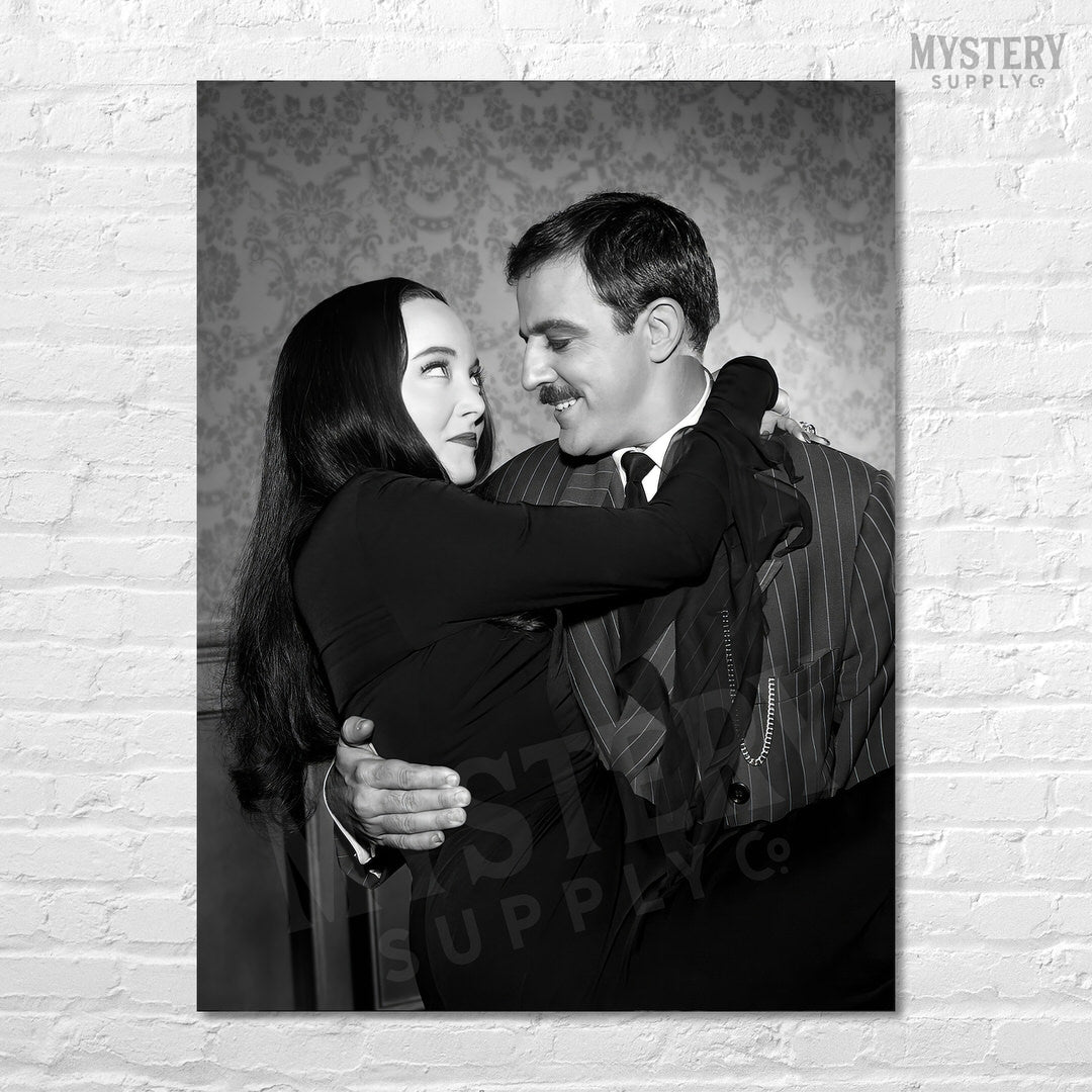 Gomez holding Morticia Addams 1960s vintage Addams family black and white photo reproduction wall decor art print from Mystery Supply Co. @mysterysupplyco