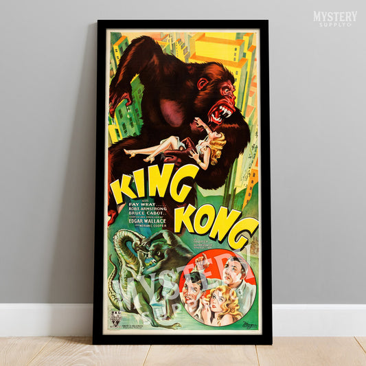 Vintage 'King Kong' movie poster with a gorilla and woman on a cityscape background, framed against a gray wall. From Mystery Supply Co.