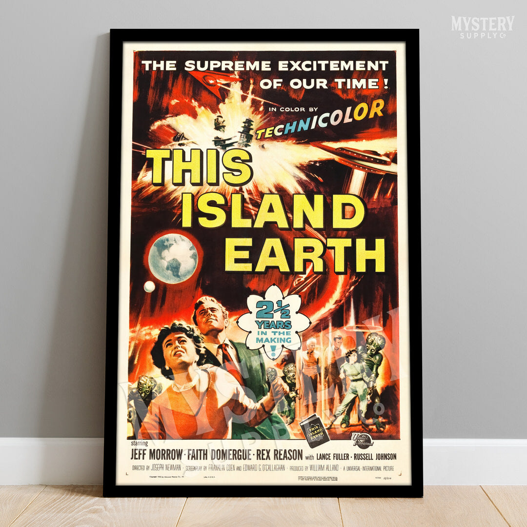 Vintage movie poster for 'This Island Earth' with vibrant colors and text on a plain wall. From Mystery Supply Co. @mysterysupplyco