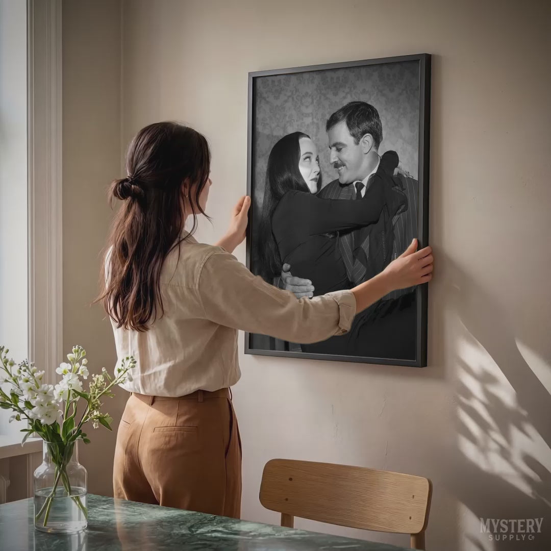 Gomez holding Morticia Addams 1960s vintage Addams family black and white photo reproduction wall decor art print from Mystery Supply Co. @mysterysupplyco