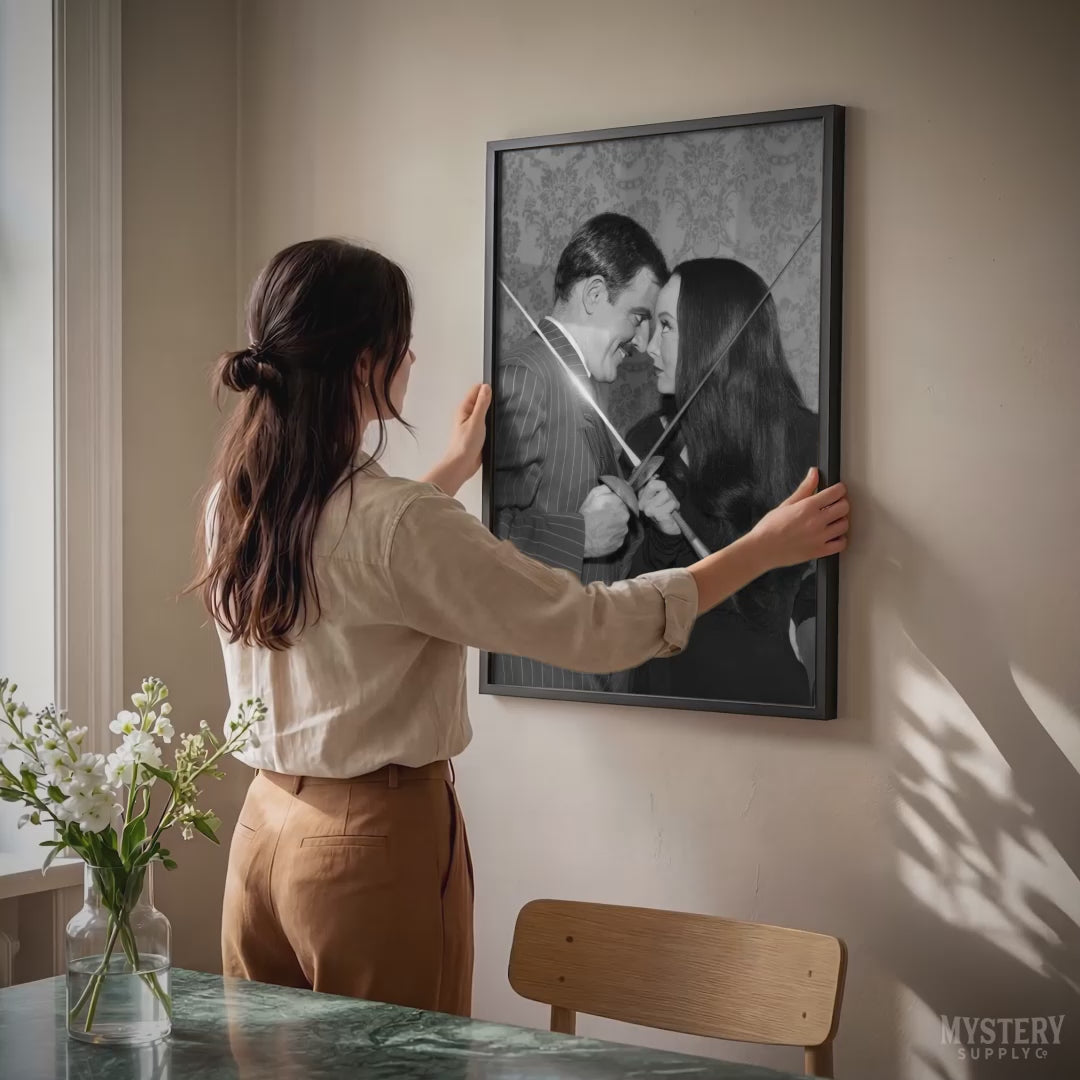 Morticia and Gomez Fencing 1960s Vintage Addams Family Black and White Photo Reproduction wall decor art print from Mystery Supply Co. @mysterysupplyco