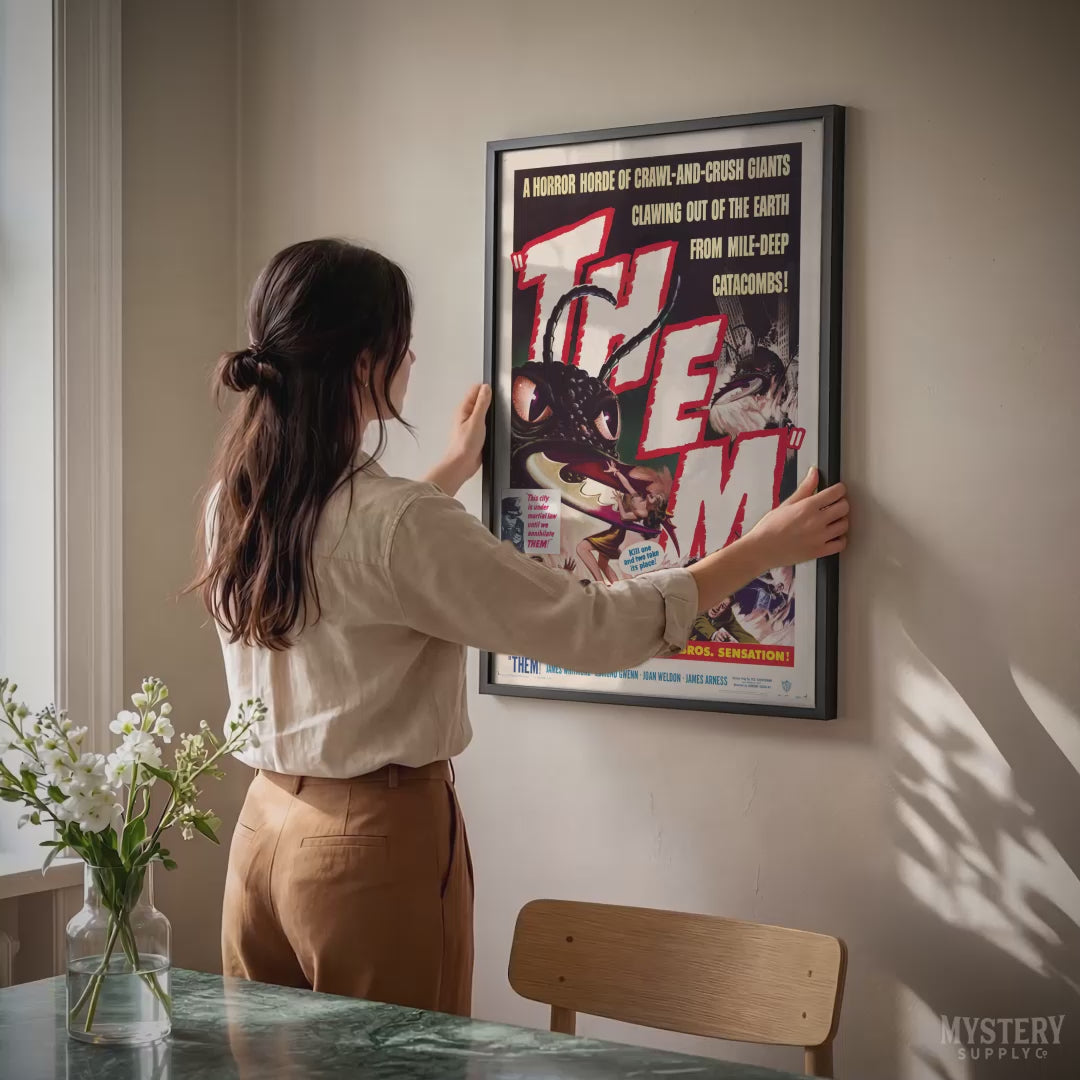 Load video: Woman hanging print from Mystery Supply Co.