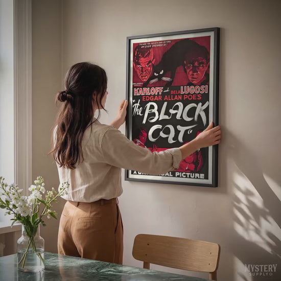 Vintage movie poster for 'The Black Cat' with classic horror imagery, framed on a wall.  From Mystery Supply Co.