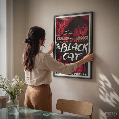 Vintage movie poster for 'The Black Cat' with classic horror imagery, framed on a wall.  From Mystery Supply Co.