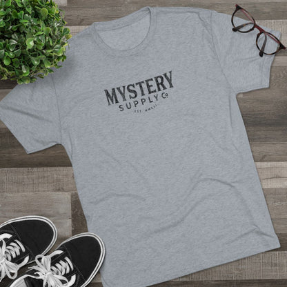 Mystery Supply Co. Classic Text Logo T-Shirt - Gray Heather on floor with shoes and glasses